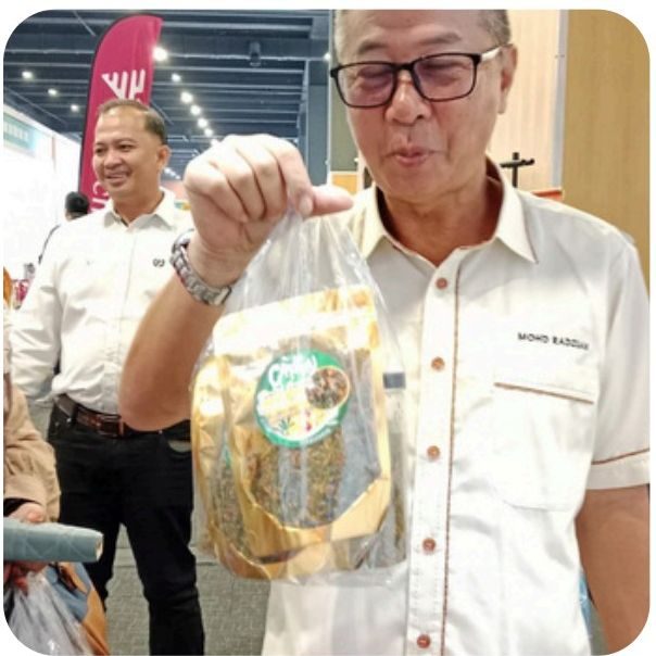 Pelawat memegang pek produk Crispy Sambal Garing